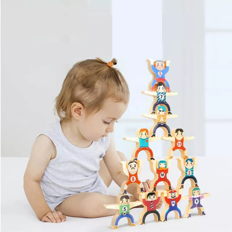 Child beside a tall tower made from colorful acrobat stacking figures
