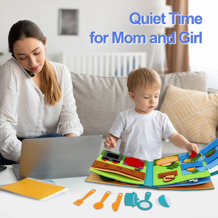A child explores an open fabric activity book beside an adult using a laptop