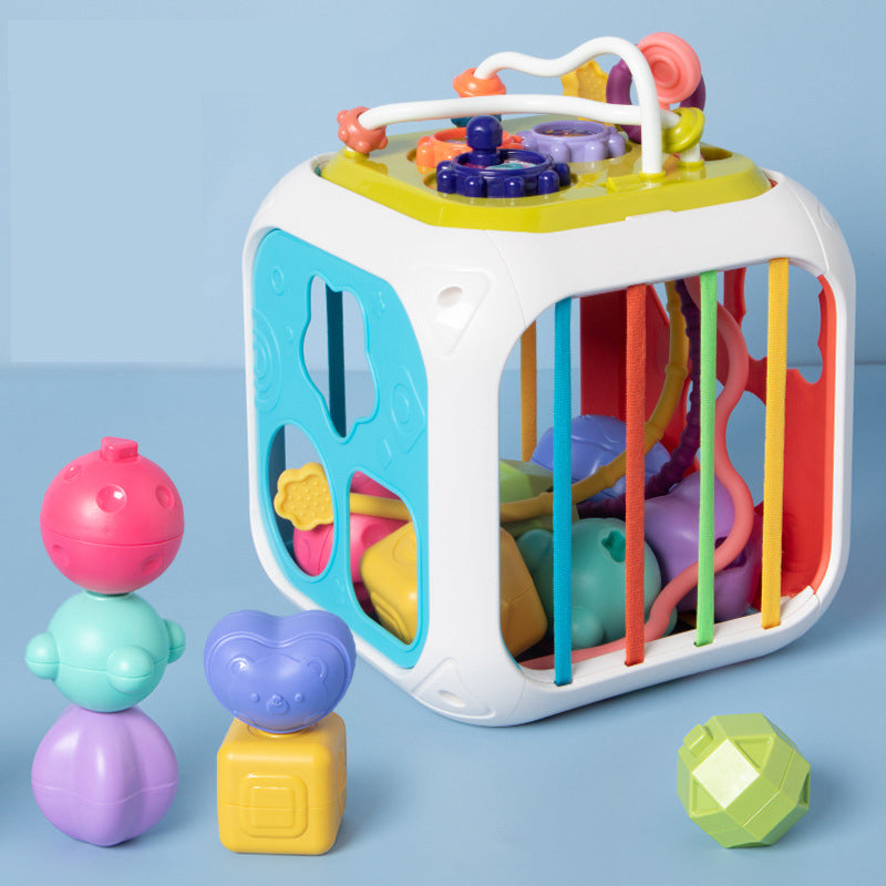 White activity cube with colorful sorting pieces, side cords, and play features on top