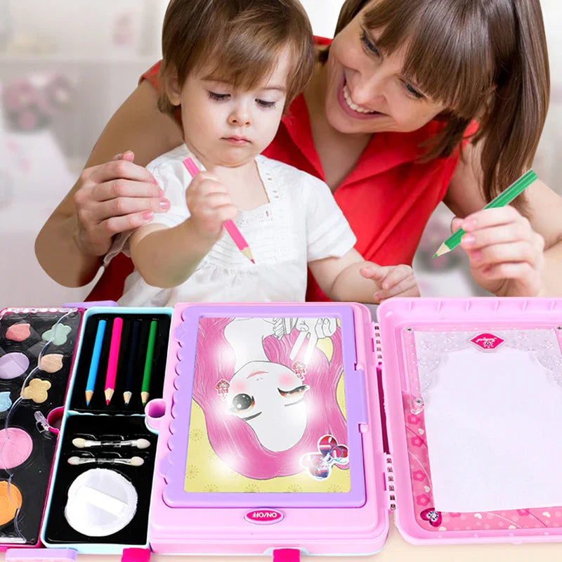 Adult and child drawing together with the pink makeup case open on a table