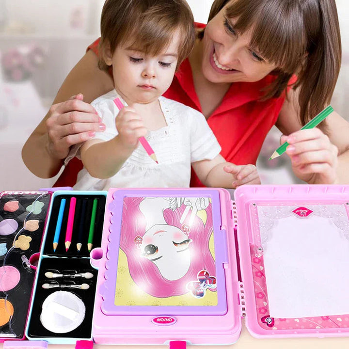 Adult and child drawing together with the pink makeup case open on a table