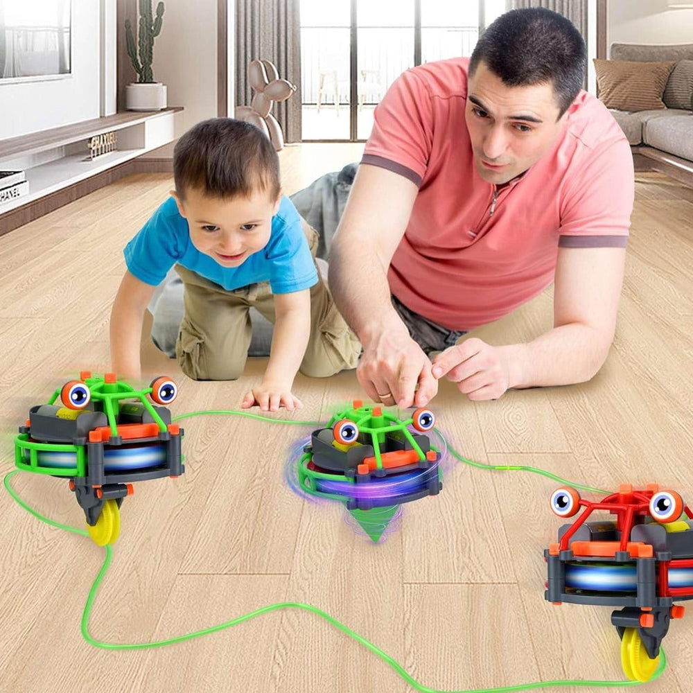 An adult and child watching green and red balancing robots beside a cord on the floor.