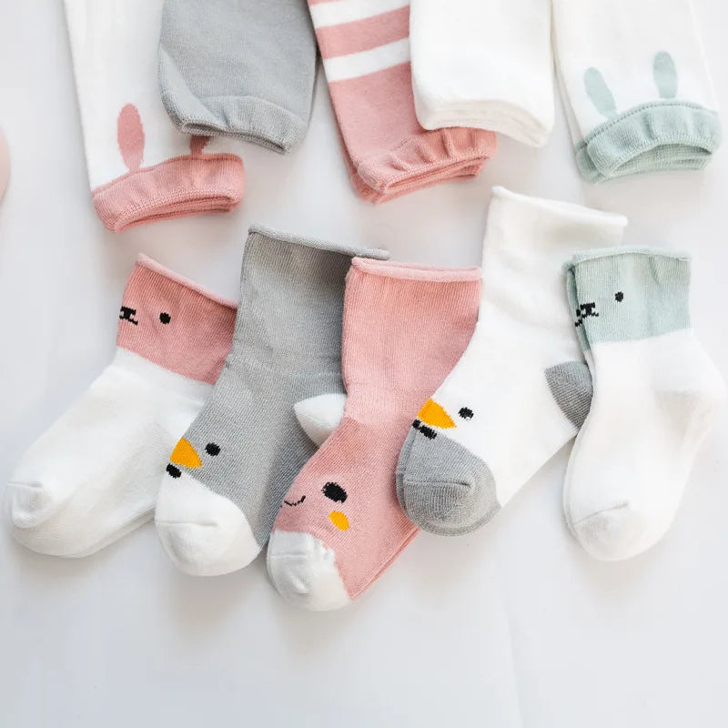 Animal-face baby socks with coordinating pink, gray, white, and pale green leg warmers.