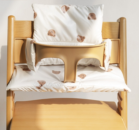 White animal-print seat and back cushions fitted to a wooden high chair
