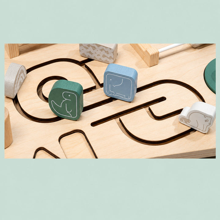Animal-marked wooden sliders on winding tabletop tracks