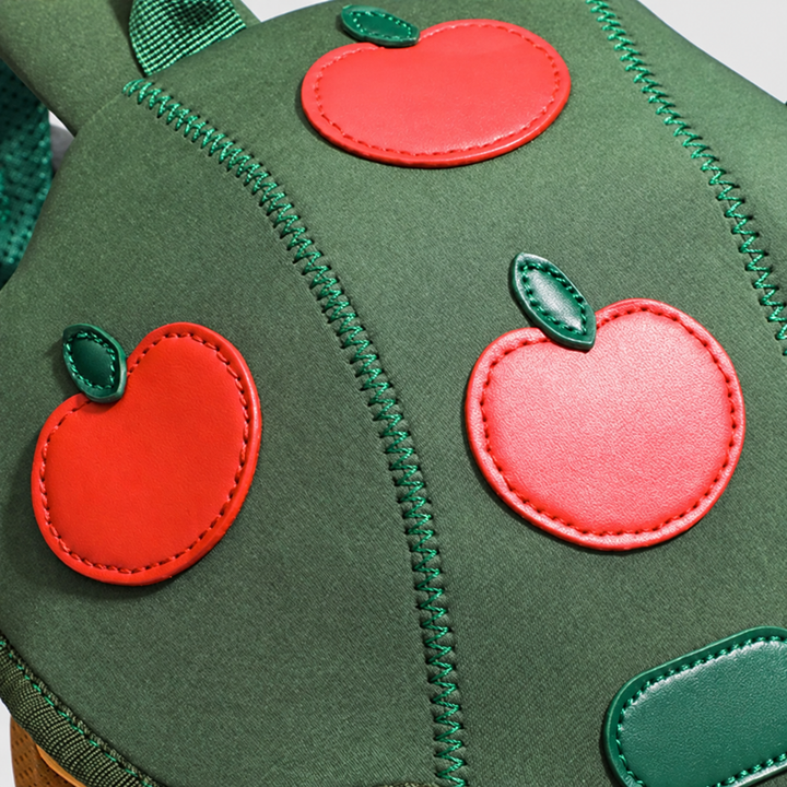 Red apple decorations and green stitching on the Apple Tree backpack&