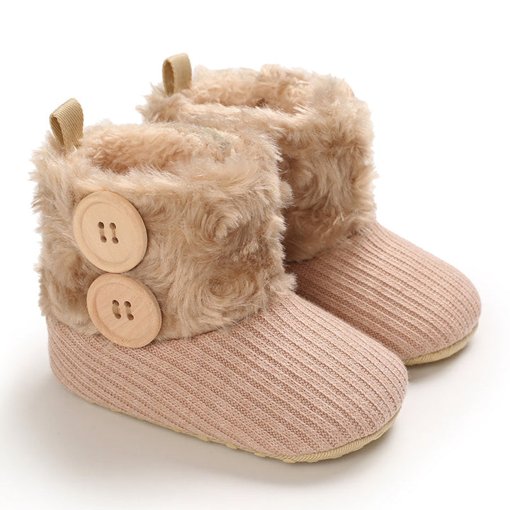 Apricot baby boots with beige plush cuffs and two decorative buttons