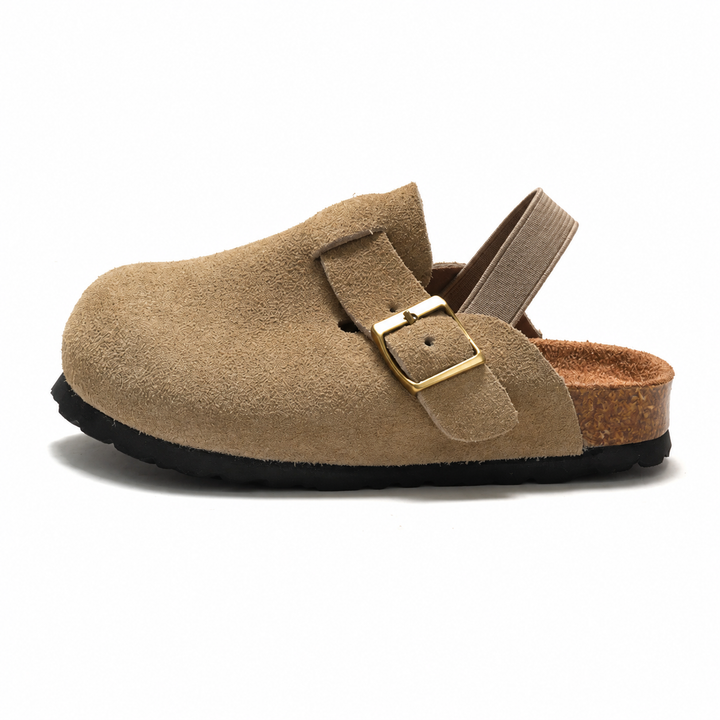 Apricot clog sandal in side view with a closed toe, buckle detail, and heel strap