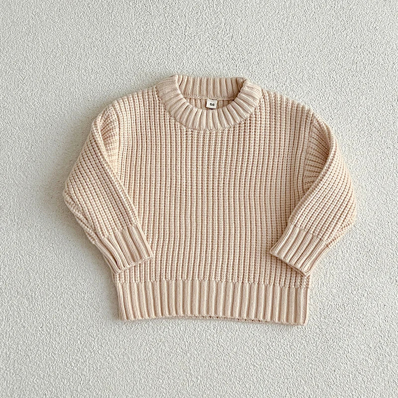 Apricot cotton knit sweater with a round neckline, long sleeves, and ribbed cuffs and hem.