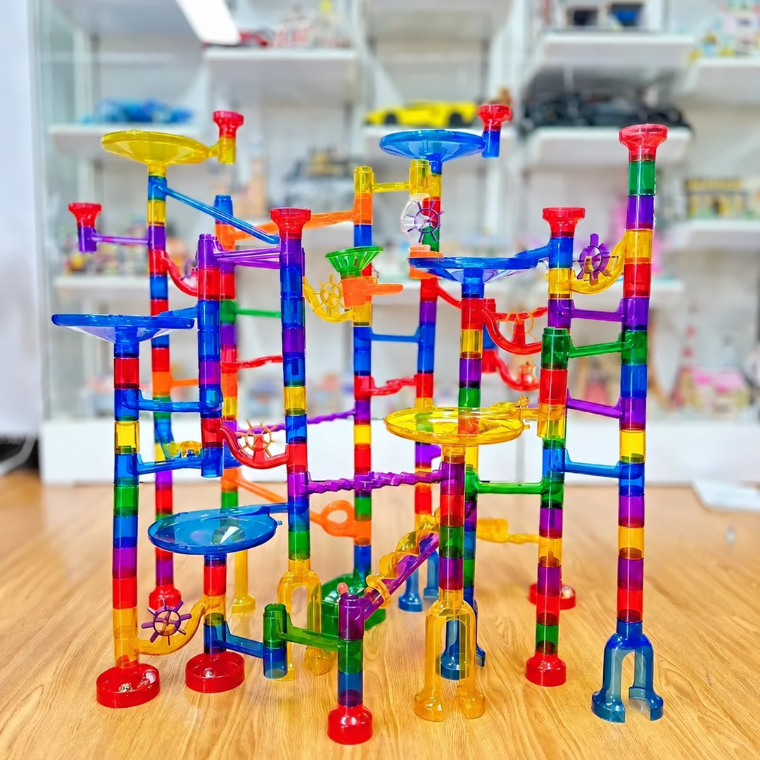 Assembled marble track with colorful columns, ramps, and blue and yellow funnels