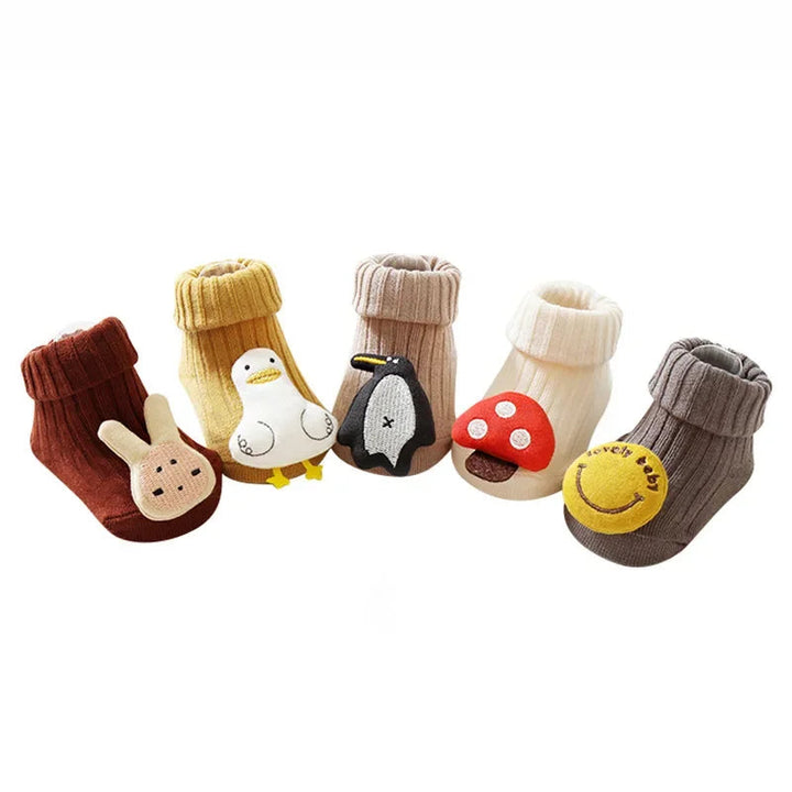 Five baby sock styles with folded cuffs and rabbit, duck, penguin, mushroom, and smiley details