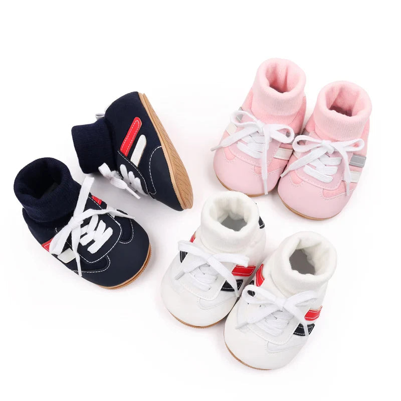 Pairs of navy, pink, and white baby shoes with contrasting side stripes and knit cuffs