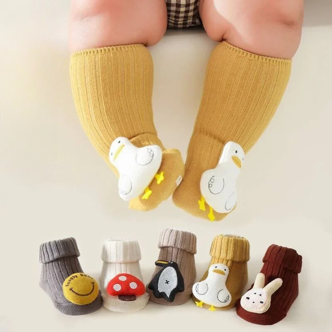 Baby wearing yellow duck socks above a row of five character sock styles