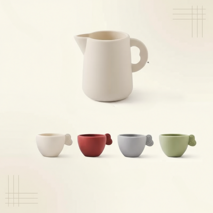 Basic tea set with a cream-colored pitcher and four cups in cream, red, gray, and green