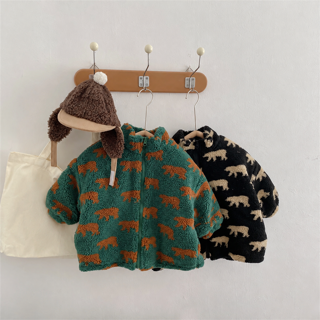 Green and black bear-print fleece jackets hanging together beside a brown hat