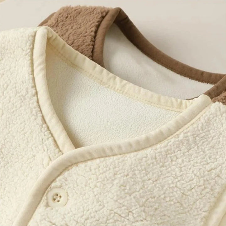 White and brown fleece vest necklines showing the lining and bound edges.