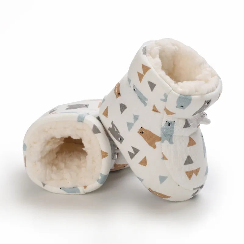 Bear-print baby slippers positioned to show the soft lining inside
