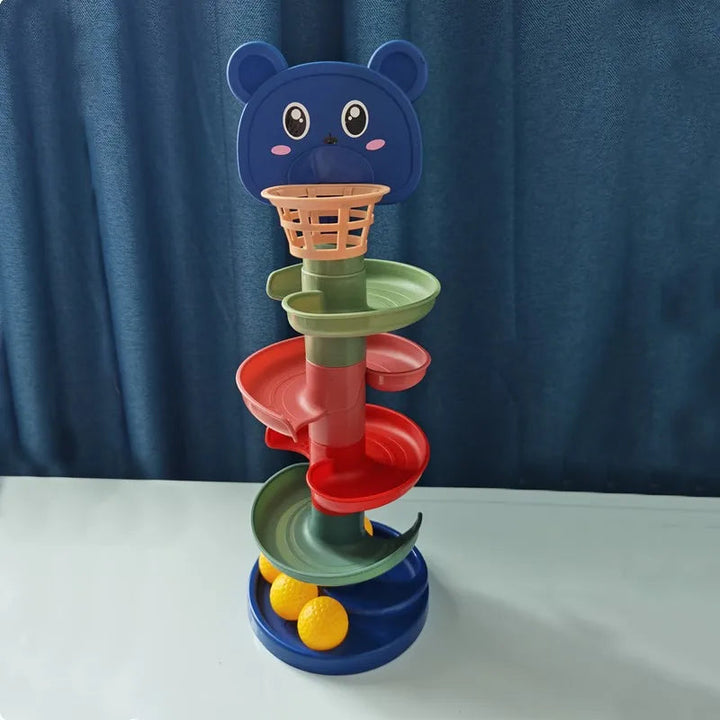 Bear-topped ball-drop tower with colorful curved tracks and yellow balls in the blue base