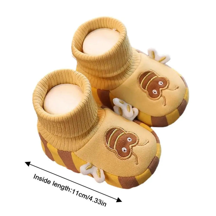 Yellow bee indoor shoes with an inside-length measurement arrow