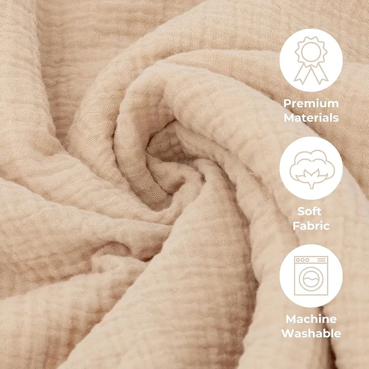 Close-up of textured beige blanket fabric with soft-fabric and machine-washable callouts