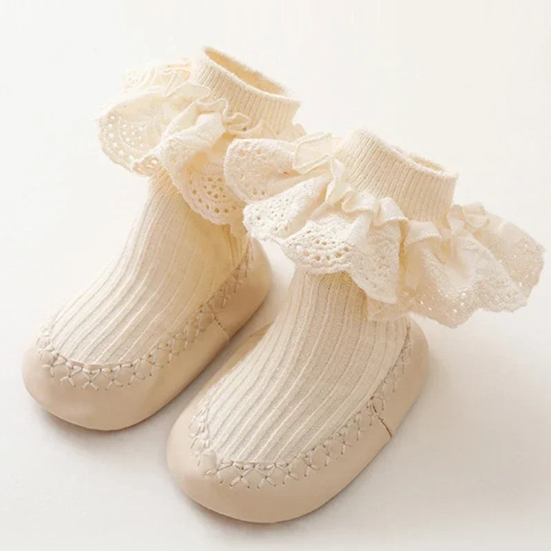 Beige baby sock shoes with cream ruffled lace cuffs and matching soles