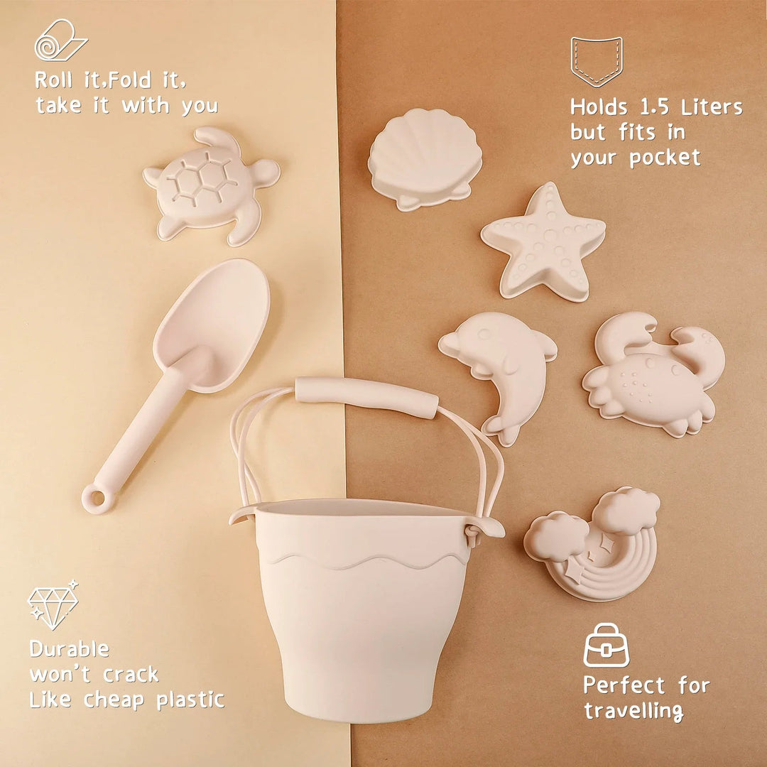 Beige silicone bucket and shovel with six sea-themed molds arranged on a brown surface.