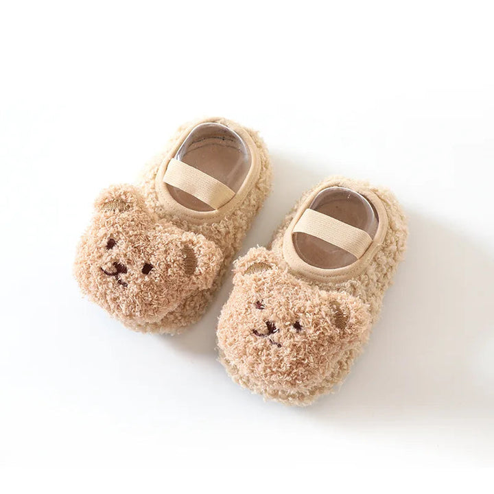 Pair of beige baby slippers with matching bear faces and elastic bands