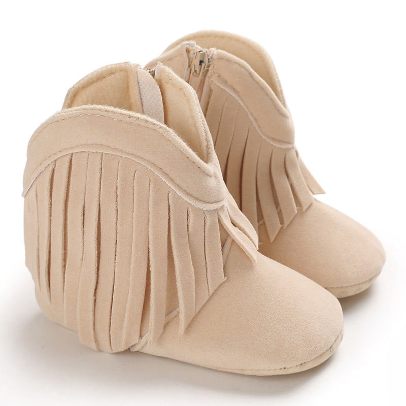 Beige baby cowboy boots with fringe trim and rounded toes