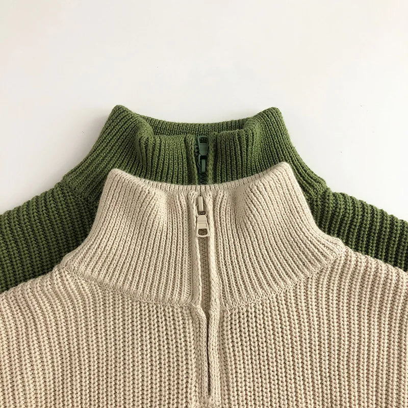 Beige and green sweater collars showing ribbed knit and short front zippers