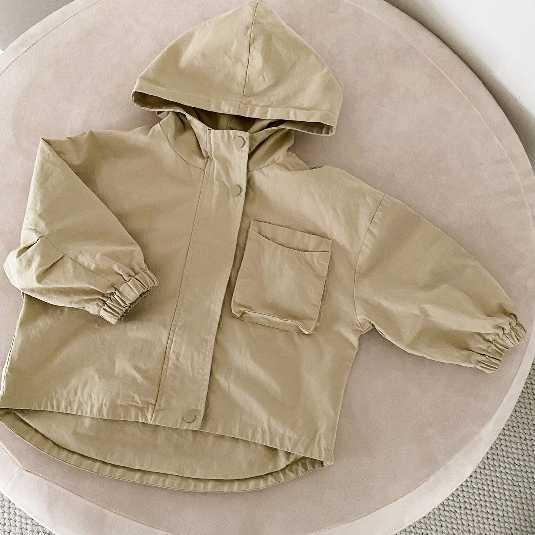 Beige hooded parka laid flat with a large chest pocket and elastic cuffs