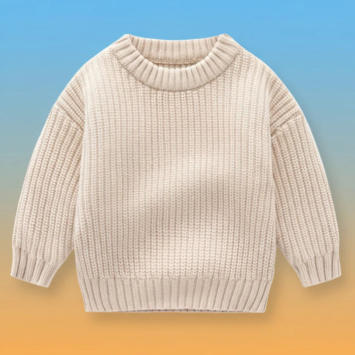 Beige knit sweater with long sleeves and ribbed neckline, cuffs, and hem.