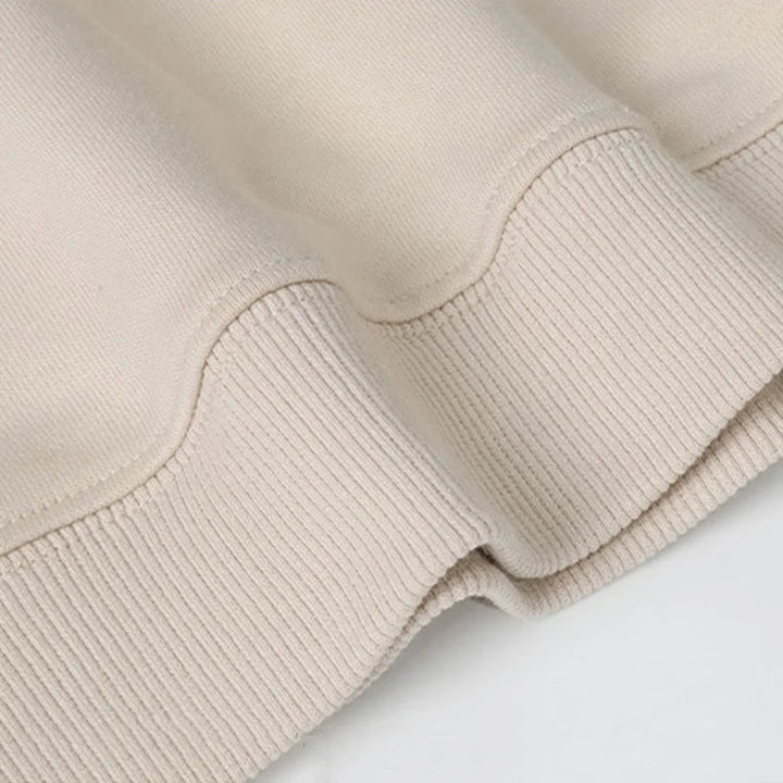 Ribbed cuffs and hem on a beige Christmas sweater