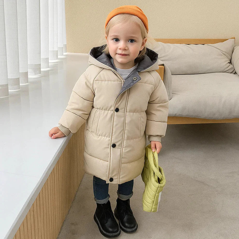 Child wearing a beige quilted winter coat with front pockets and button details