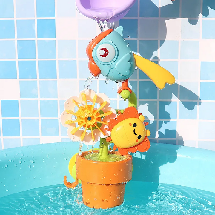 Water poured over the bird bath toy above its flower wheels and orange bucket