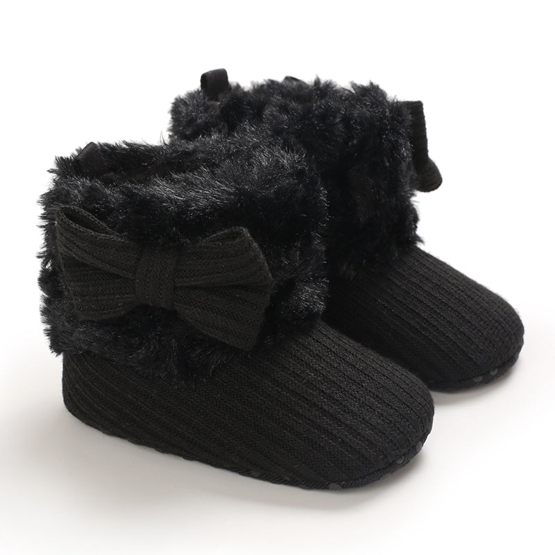 Black baby winter boots with ribbed uppers, plush cuffs, and matching bows