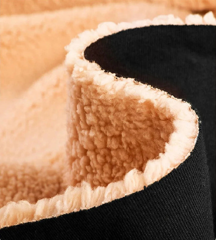 Close-up of cream fleece lining against the black hoodie&
