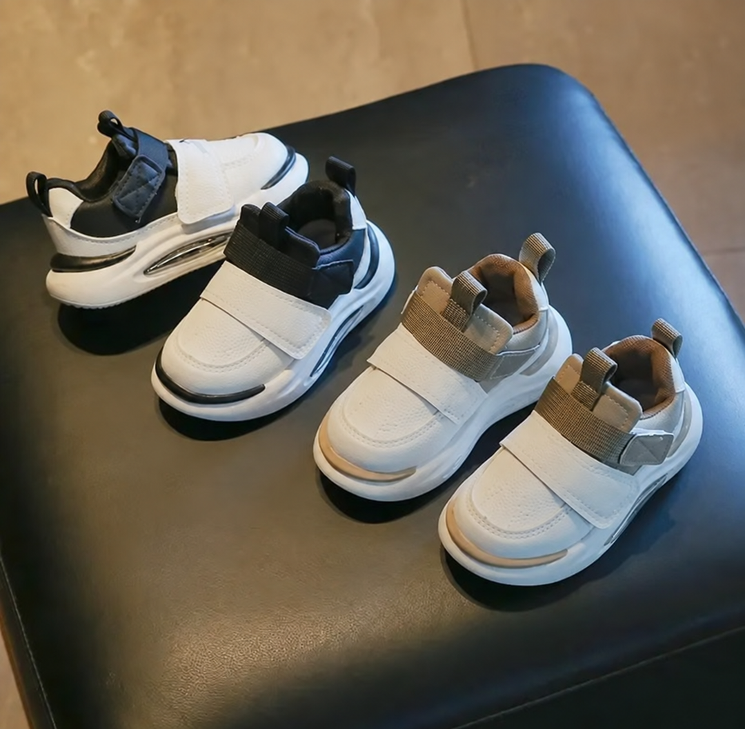 Black and khaki sneaker pairs displayed together with white uppers and thick soles