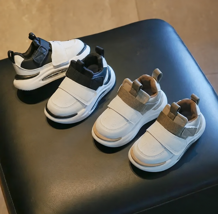 Black and khaki sneaker pairs displayed together with white uppers and thick soles