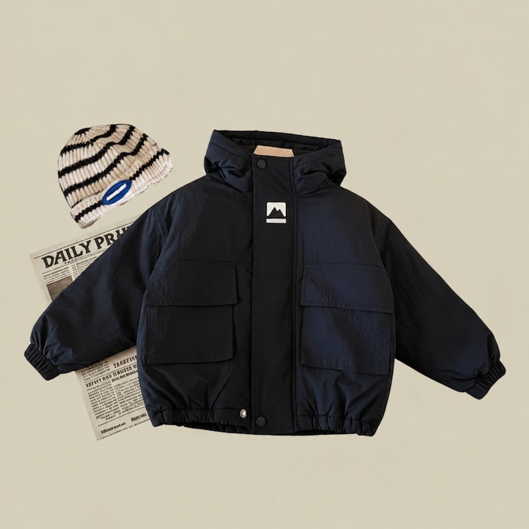 Black kids' windbreaker shown from the front with flap pockets and elastic cuffs