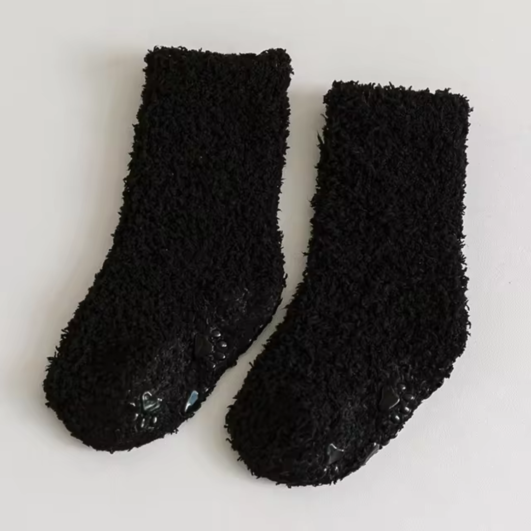Black fleece socks with paw-print details on the soles