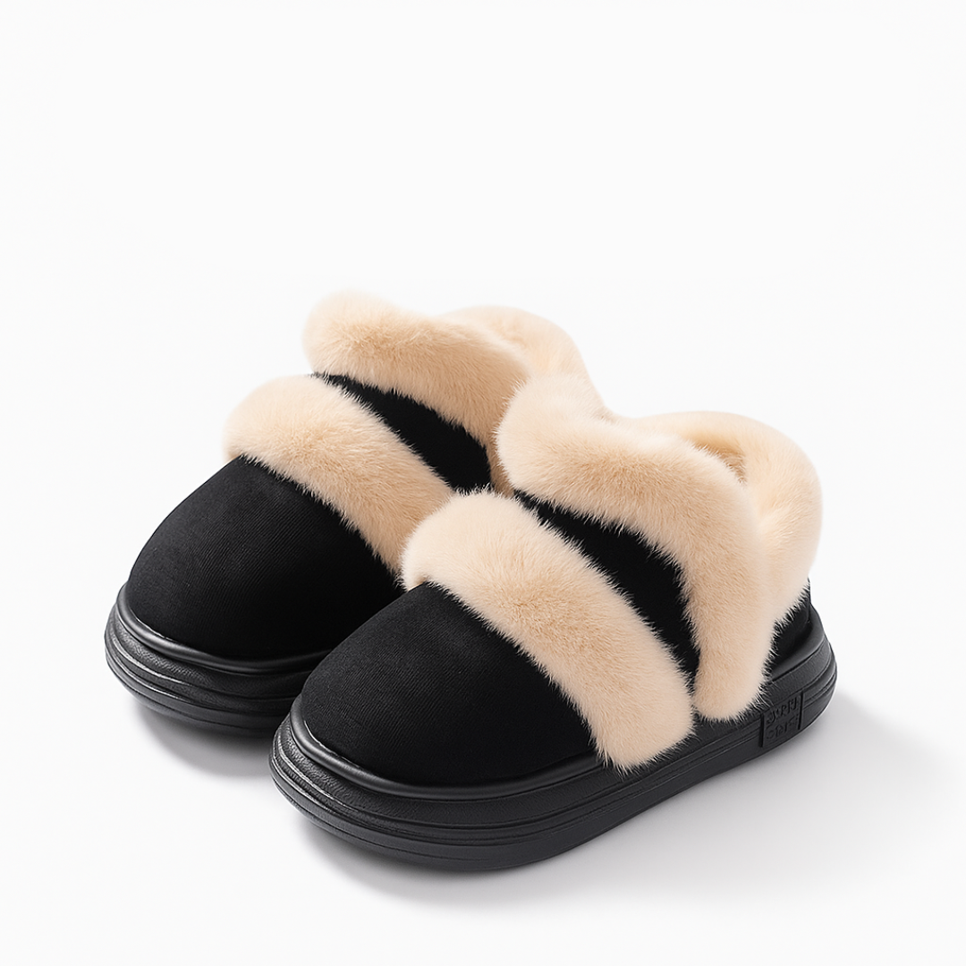 Black ankle boots with cream plush trim and black soles.