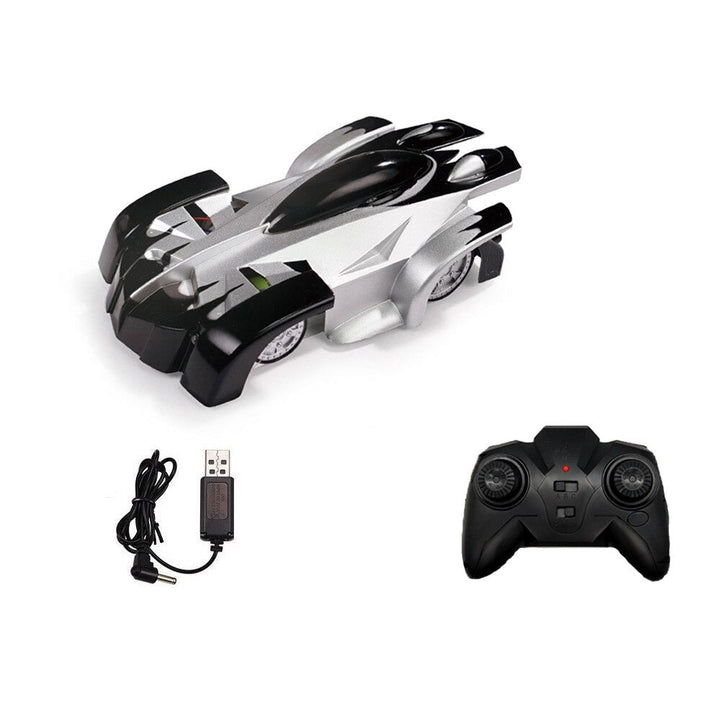 Black-and-silver remote-control car with its black controller and USB charging cable