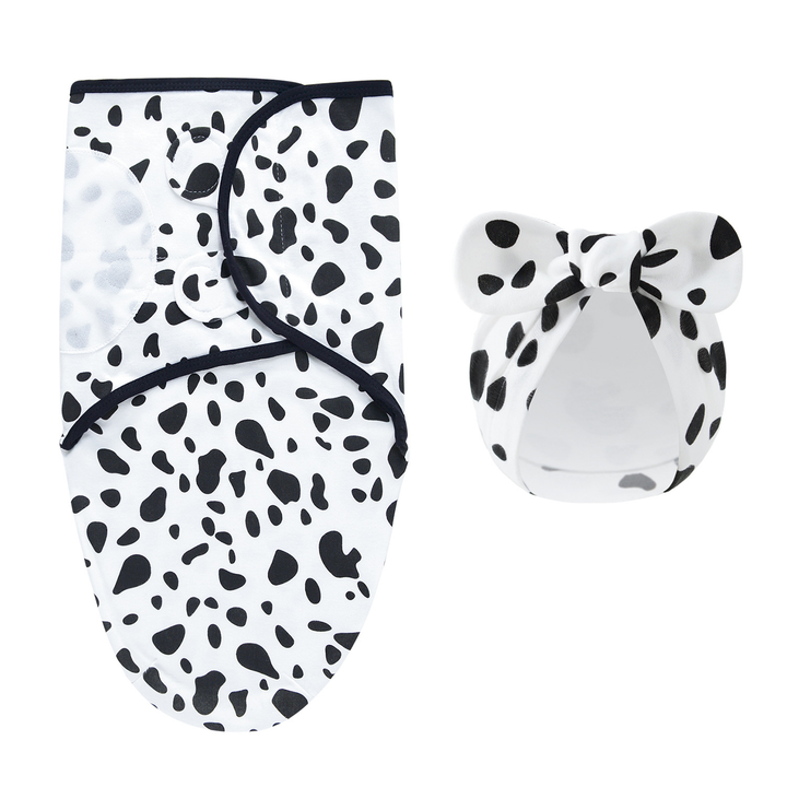 White swaddle blanket and matching bow hat with black Dalmatian-style spots