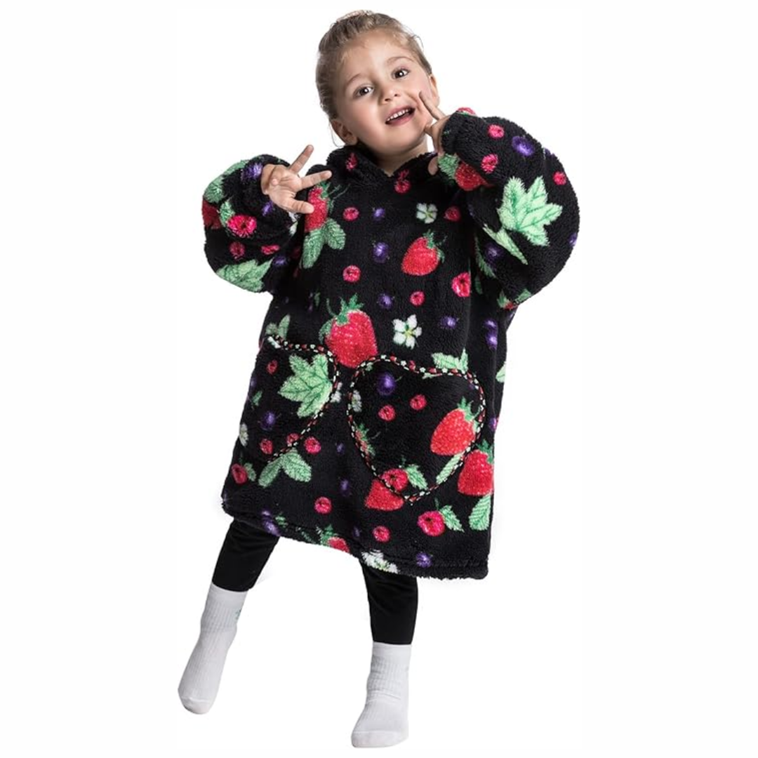 Child wearing a black hooded blanket with red strawberry prints