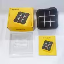 Black electronic tic-tac-toe game displayed with its box and instruction manual