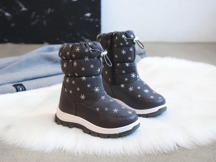 Pair of black snowflake-print winter boots with white midsoles and drawcord cuffs