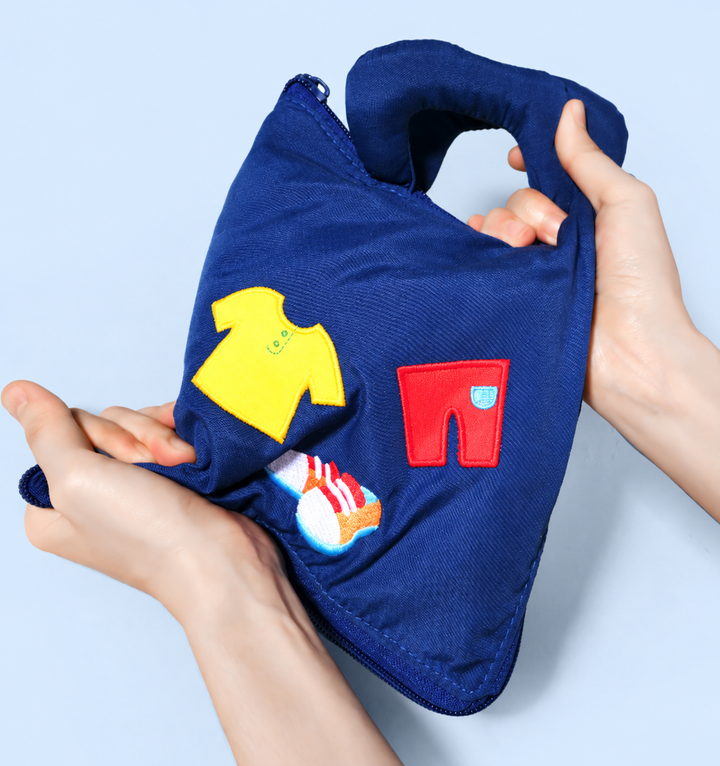 Soft blue activity book with carry handles and colorful clothing appliques