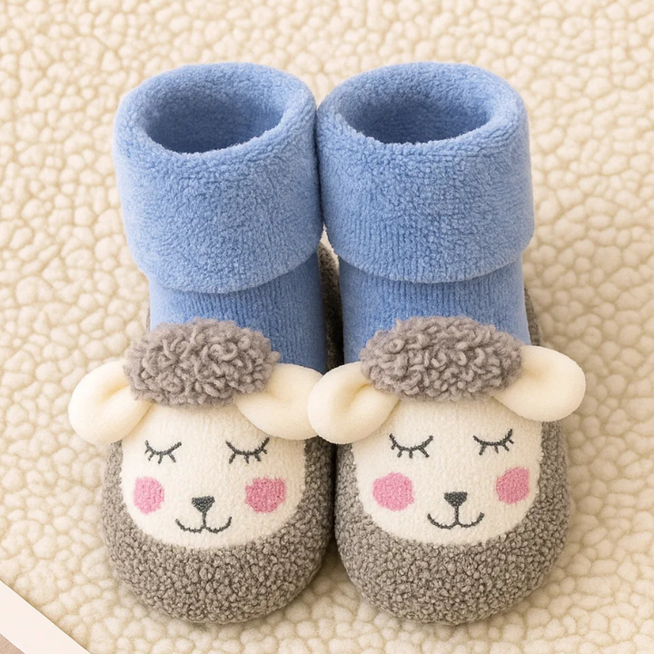Blue baby socks with gray toes, cream animal faces, raised ears, and fold-over cuffs