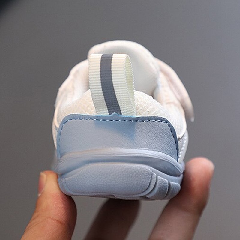 Rear view of a blue baby sneaker showing the heel panel and striped pull tab