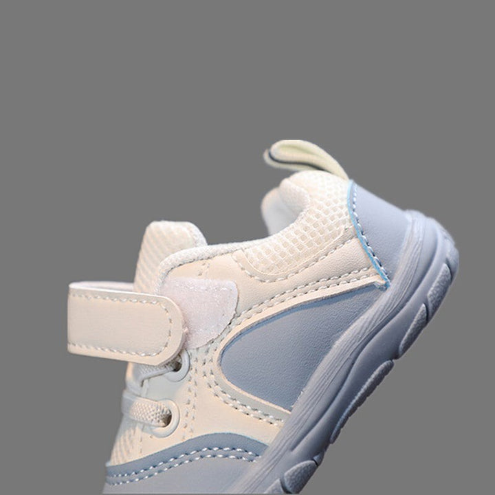 Side view of a blue baby sneaker with its white hook-and-loop strap open
